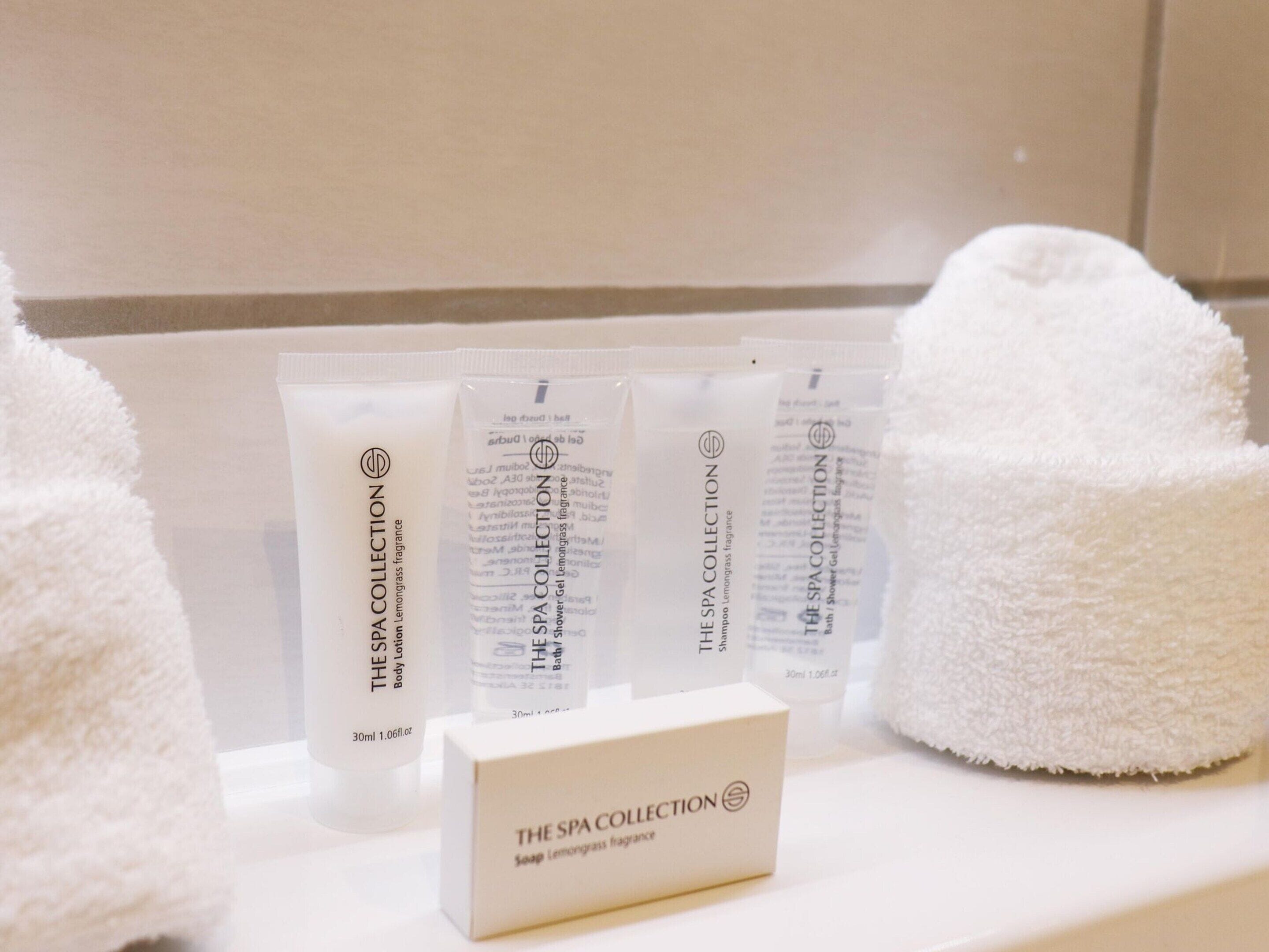 A display of The Spa Collection body lotion and shampoo, along with a box of the same collection.