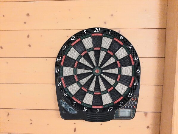 A dartboard mounted on a wooden wall.