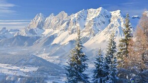 A mountainous landscape with snow-covered peaks and trees. - Comfortable Holiday Home in Kleinarl (Kleinarl)