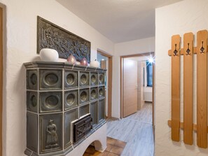 Stunning hallway leading to a bedroom with a decorative cabinet and intricate metal artwork.