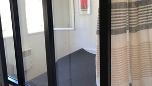 A room with a bed, a window, a door, and a wall-mounted picture. - Villa, golden island view, a stone's throw from the beach. Breathtaking view! (Saint-Raphaël)