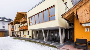 A modern building with a large window, a balcony, and a checkered floor. - Chalet in Stuhlfelden Near Ski Slopes (Mittersill)