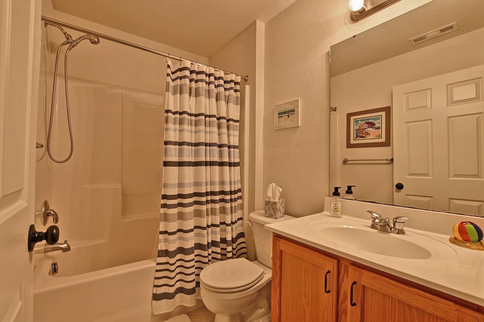 A bathroom with a bathtub, toilet, and sink.