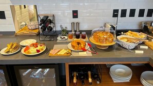 Ein Buffet mit verschiedenen Speisen, Weinflaschen und Gewürzen.