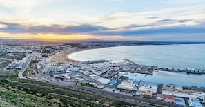 Overlooking a wide, curved beachfront, this city offers stunning views of a marina and modern urban architecture.