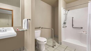 A bathroom with a toilet, sink, and shower. - Travelodge By Wyndham Wellington (Wellington)