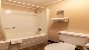 A bathroom with a bathtub, toilet, and a towel rack. - Hotel Wadsworth OH I-76 (Wadsworth)