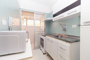 Enjoy cooking in this kitchen with an oven, microwave, and stainless steel sink.