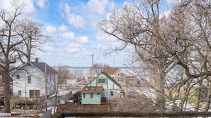 A residential area with houses, a wooden fence, and leafless trees. - This property is conviently located in Lakeside, within minutes from the Lake. (Muskegon)