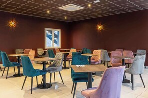 A dining area with multiple tables and chairs, a ceiling with recessed lighting, and a window with a view. - Best Western Hotel & SPA Pau Lescar Aeroport (Lescar)