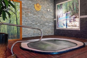 A hot tub with a wooden floor, a wall clock, and a large window with a forest view. - Best Western Hotel & SPA Pau Lescar Aeroport (Lescar)
