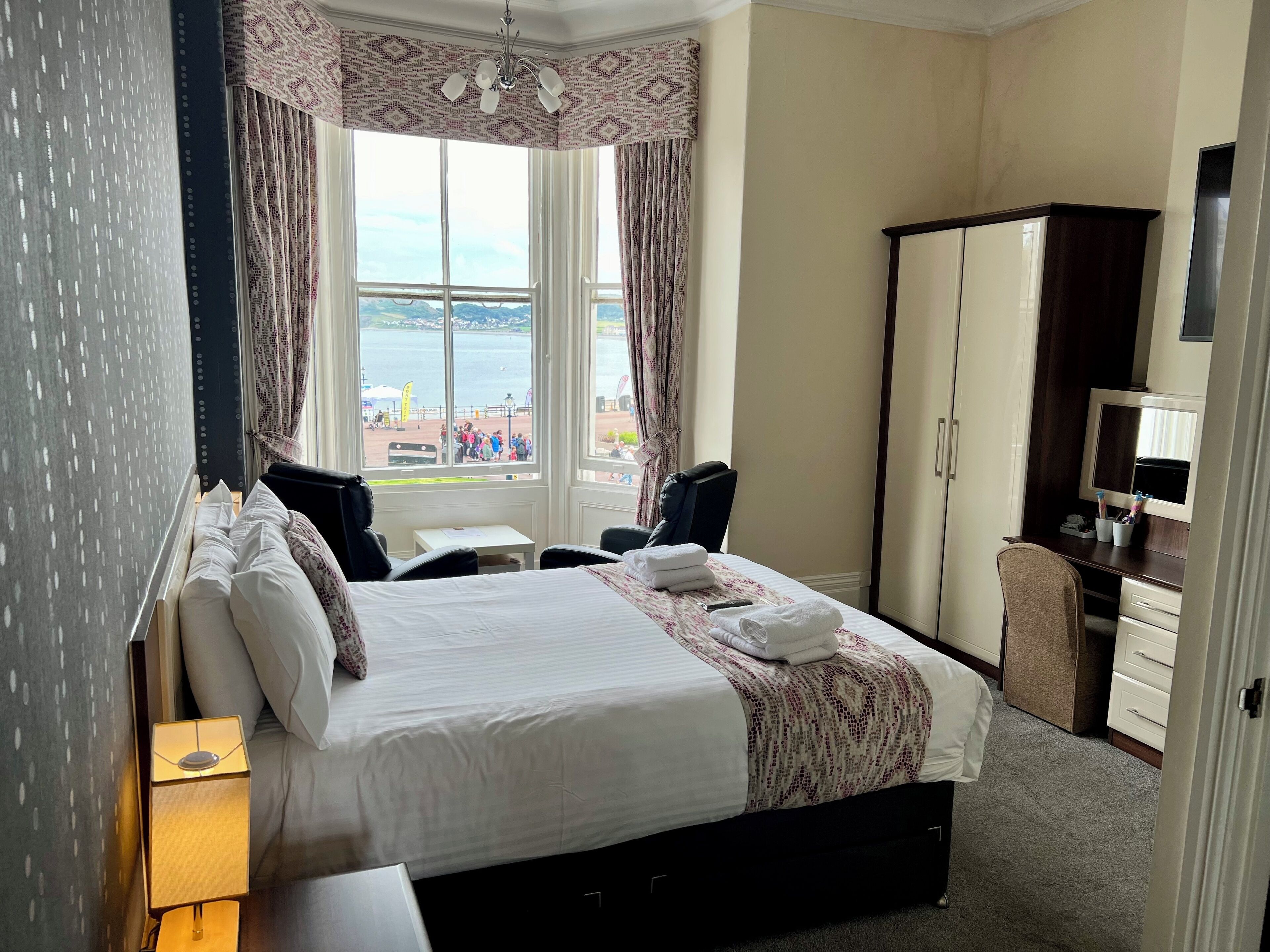 Premium bedding, desk, laptop workspace, blackout curtains