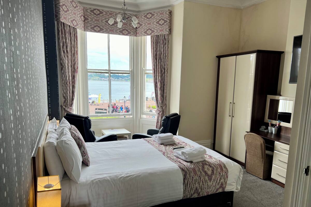 Premium bedding, desk, laptop workspace, blackout curtains