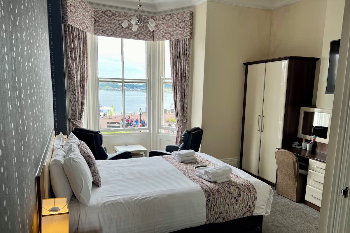 Premium bedding, desk, laptop workspace, blackout curtains