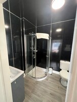 Junior Triple Room | Bathroom | Shower, free toiletries, hair dryer, towels