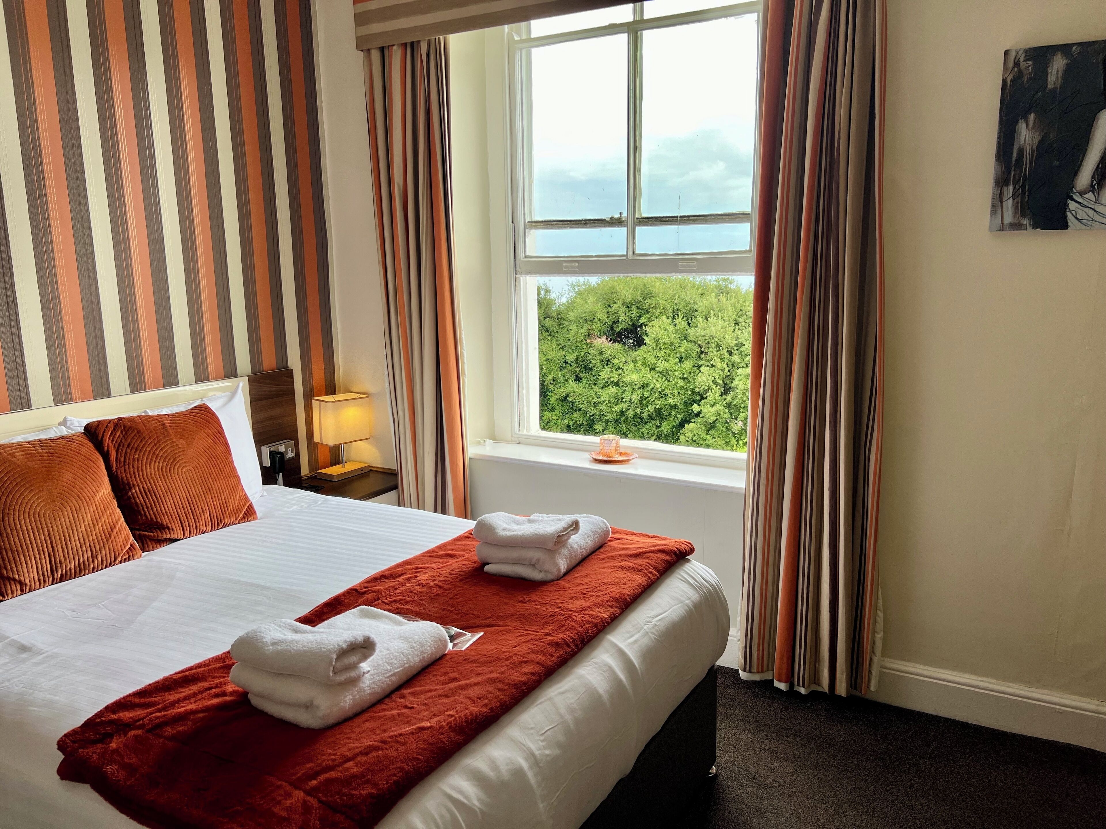 Premium bedding, desk, laptop workspace, blackout curtains