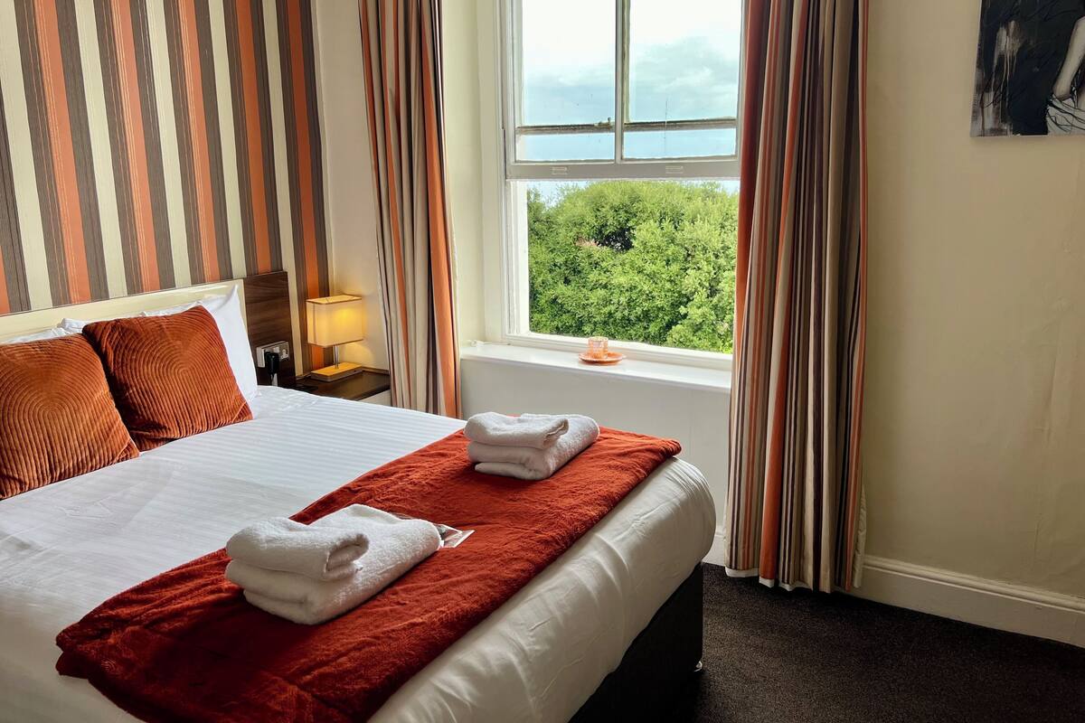 Premium bedding, desk, laptop workspace, blackout curtains