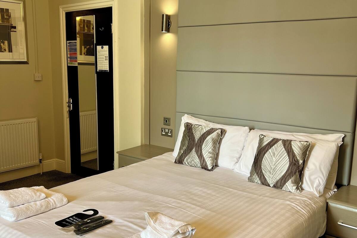 Premium bedding, desk, laptop workspace, blackout curtains