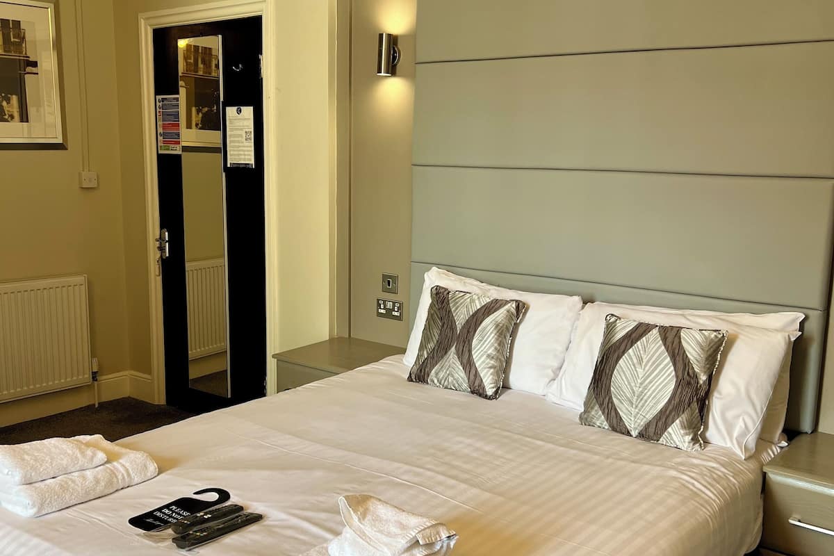 Premium bedding, desk, laptop workspace, blackout curtains