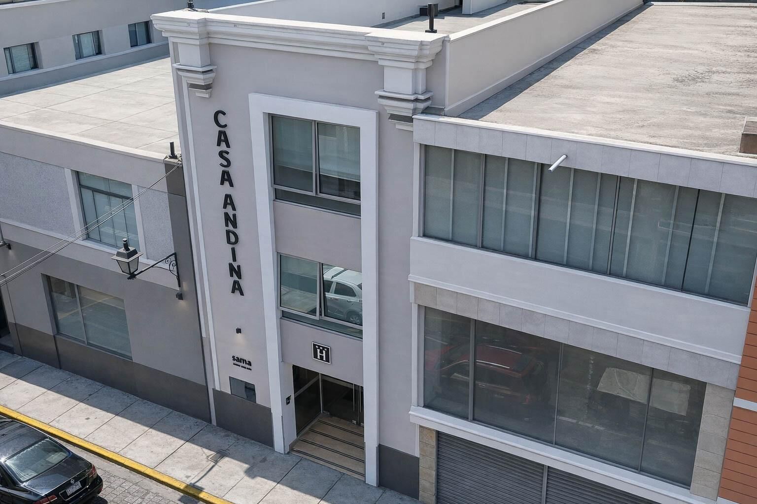 A multi-story building with a prominent 'CASA ANDINA' sign on the facade.