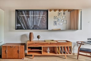 A room with a wooden console table, a vintage suitcase, a globe, and framed pictures on the wall. - Live Aqua San Miguel de Allende (San Miguel de Allende)