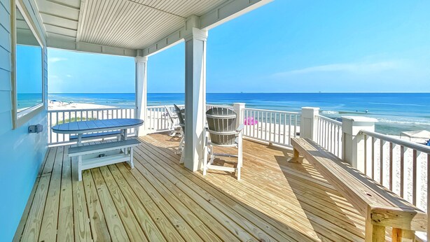 A wooden deck with a bench and chairs, overlooking a beach and ocean. - Perfect, beachfront pet friendly 5 bedroom home, close to waters (Gulf Shores)
