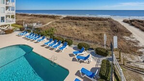 A pool area with lounge chairs and a view of the beach. - Beachfront Bliss Ocean Pier 4 Oceanfront 2 bed 2 bath Windy Hill (North Myrtle Beach)