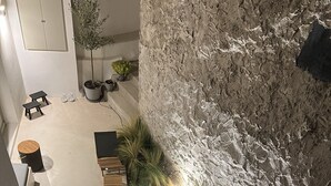 A spa area with a hot tub, seating, and plants. - Fully equiped, spacious cozy apartment (Paros)