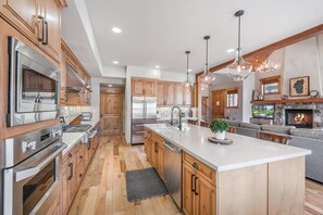 Enjoy cooking and socializing in this kitchen with a large island, sink, and ample counter space.