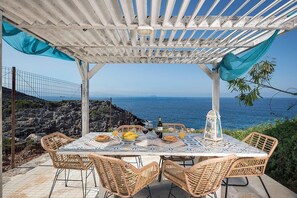 Enjoy a romantic meal for two under the shade of a pergola with a scenic ocean view.
