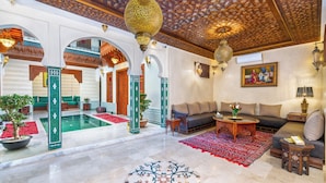 A luxurious interior with a pool, seating areas, and ornate ceiling design. - Riad Diamond Of Marrakech (Marrakech)