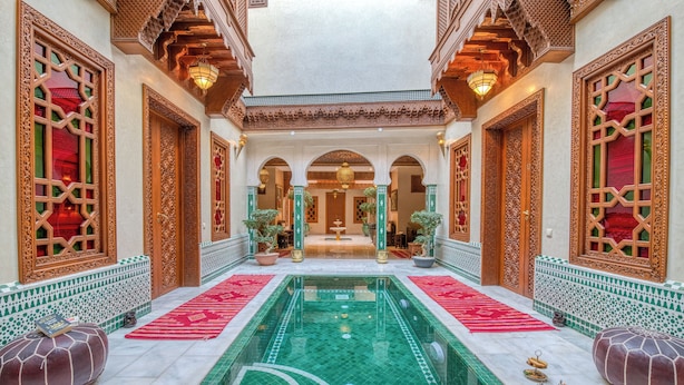 A luxurious indoor pool area with intricate tile work and ornate wooden doors. - Riad Diamond Of Marrakech (Marrakech)