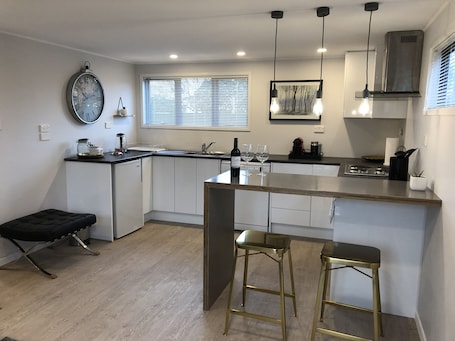 Fridge, microwave, oven, stovetop. Self contained Studio walking distance to Mission Estate