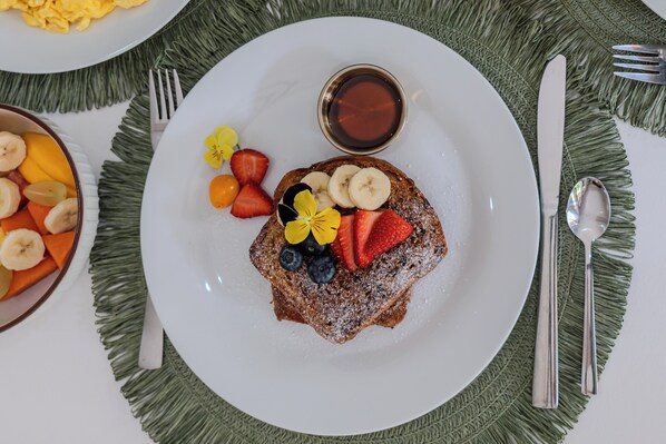 A breakfast plate with toast, fruit, and syrup. - Natüra Hotel Monteverde (Monteverde)