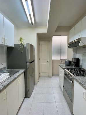 Fridge, microwave, electric kettle, cookware/dishes/utensils