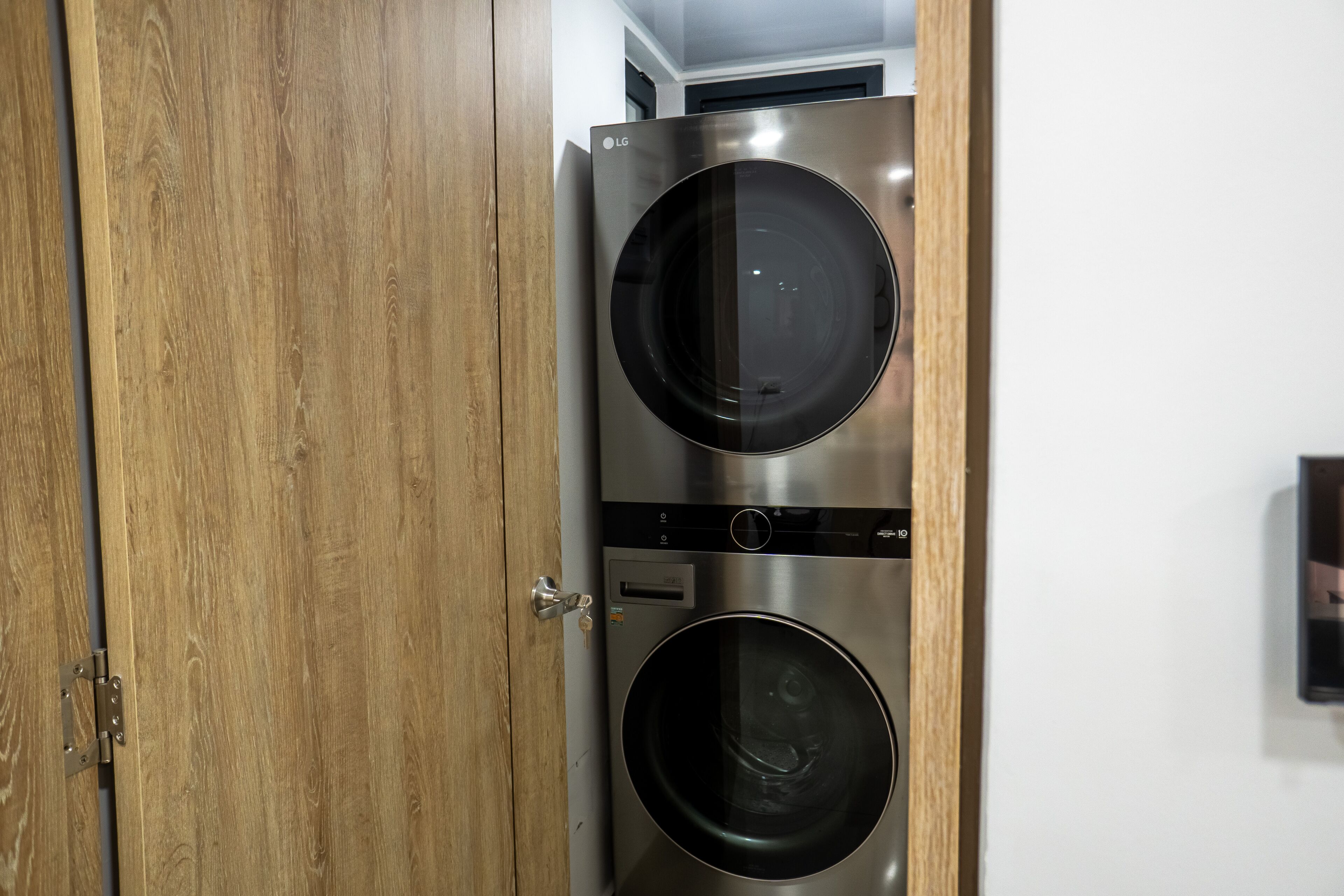 A double-door wardrobe with a metallic handle and a small label on the door.