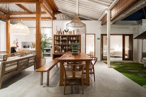 Cozy living space with a dining table, seating area, and bookshelf.