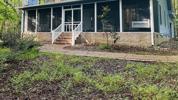A single-story house with a covered porch, a brick foundation, and a metal roof. - Charming 3 BR, 2 Bath cabin located in quiet Clifftops and close to Sewanee (Monteagle)