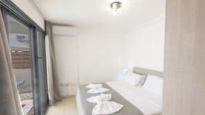 A hotel room with a bed, a window, and a door. - Protaras Holiday Villa My5 (Protaras)