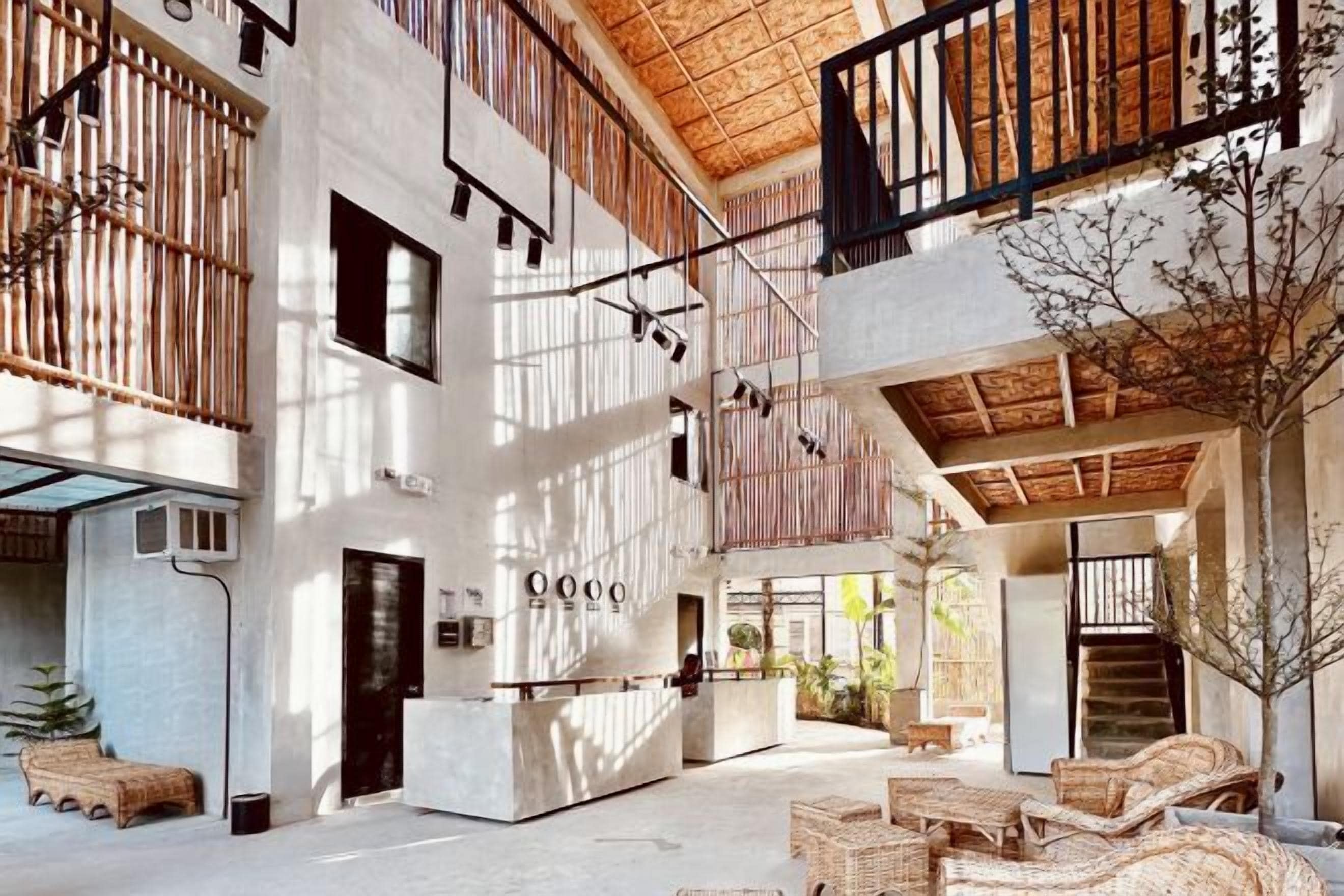A spacious lobby with high ceilings, a reception desk, and seating areas.