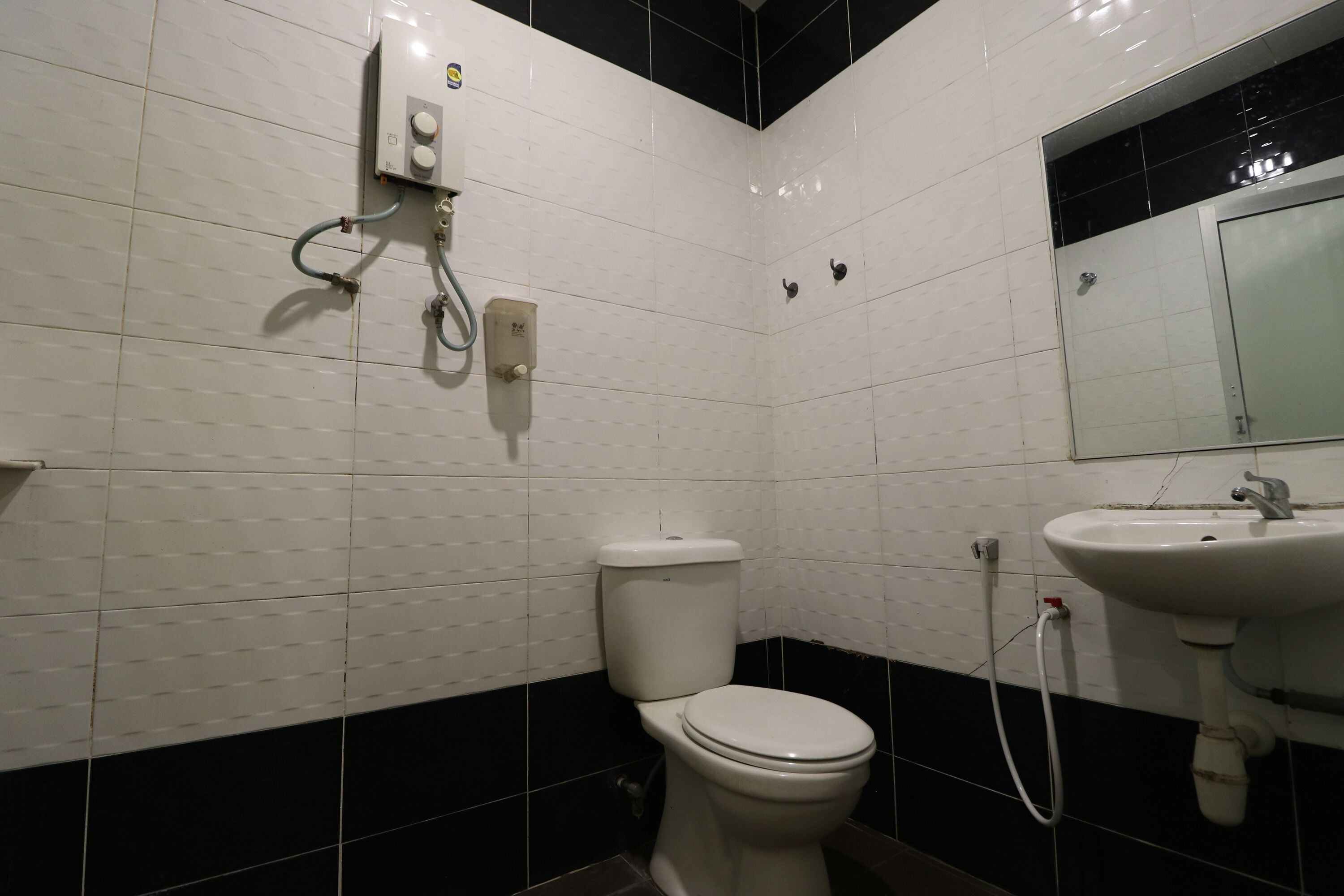 A bathroom with a toilet, a sink, and a shower.