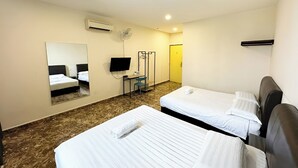 A hotel room with two beds, a desk with a chair, a TV, and a mirror.