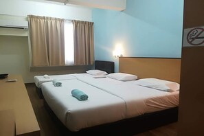 A hotel room with a bed, a desk, and a window with curtains. - Hotel 75 Temerloh (Temerloh)