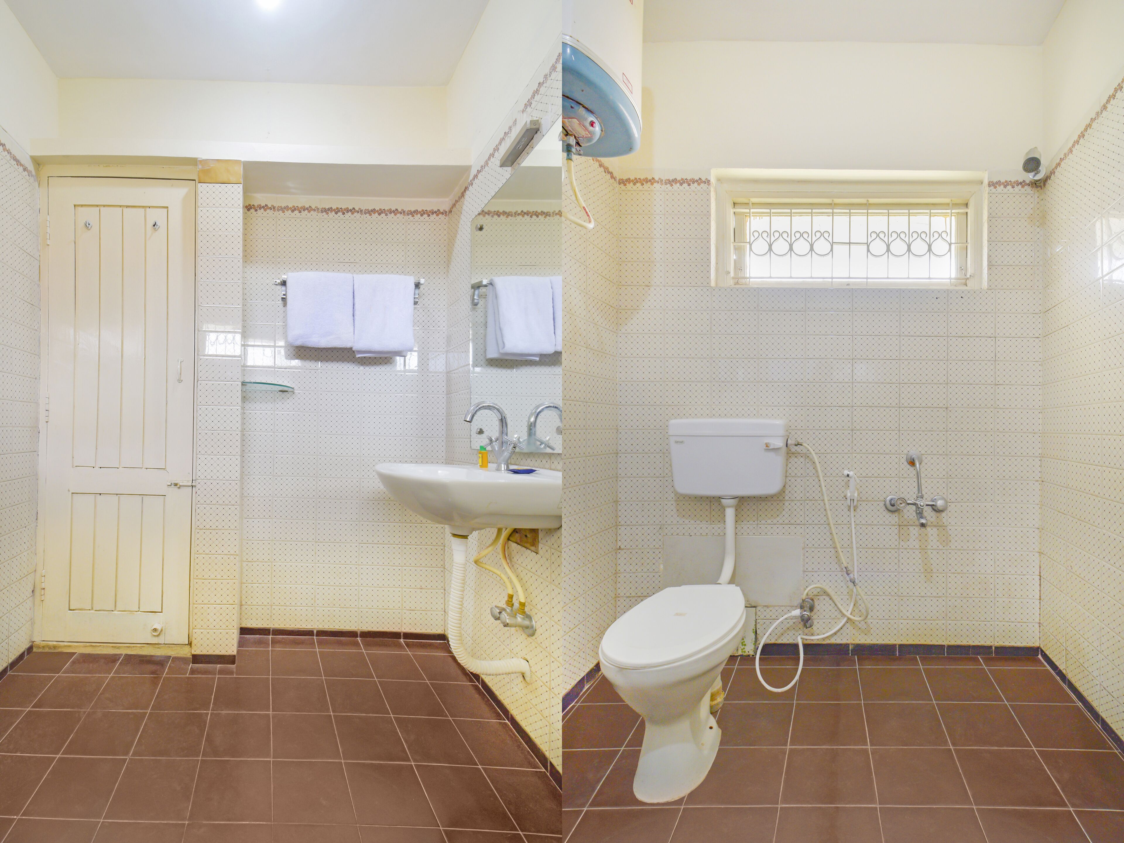 A bathroom with a toilet, sink, and shower. There is a door and a window with bars.
