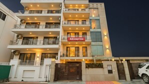 A multi-story building with a 'Fabexpress' sign, balconies, and a gated entrance. - Via Hemkunt Residency - Nr Yatharth Super Speciality Hospital - Noida 110 (Noida)