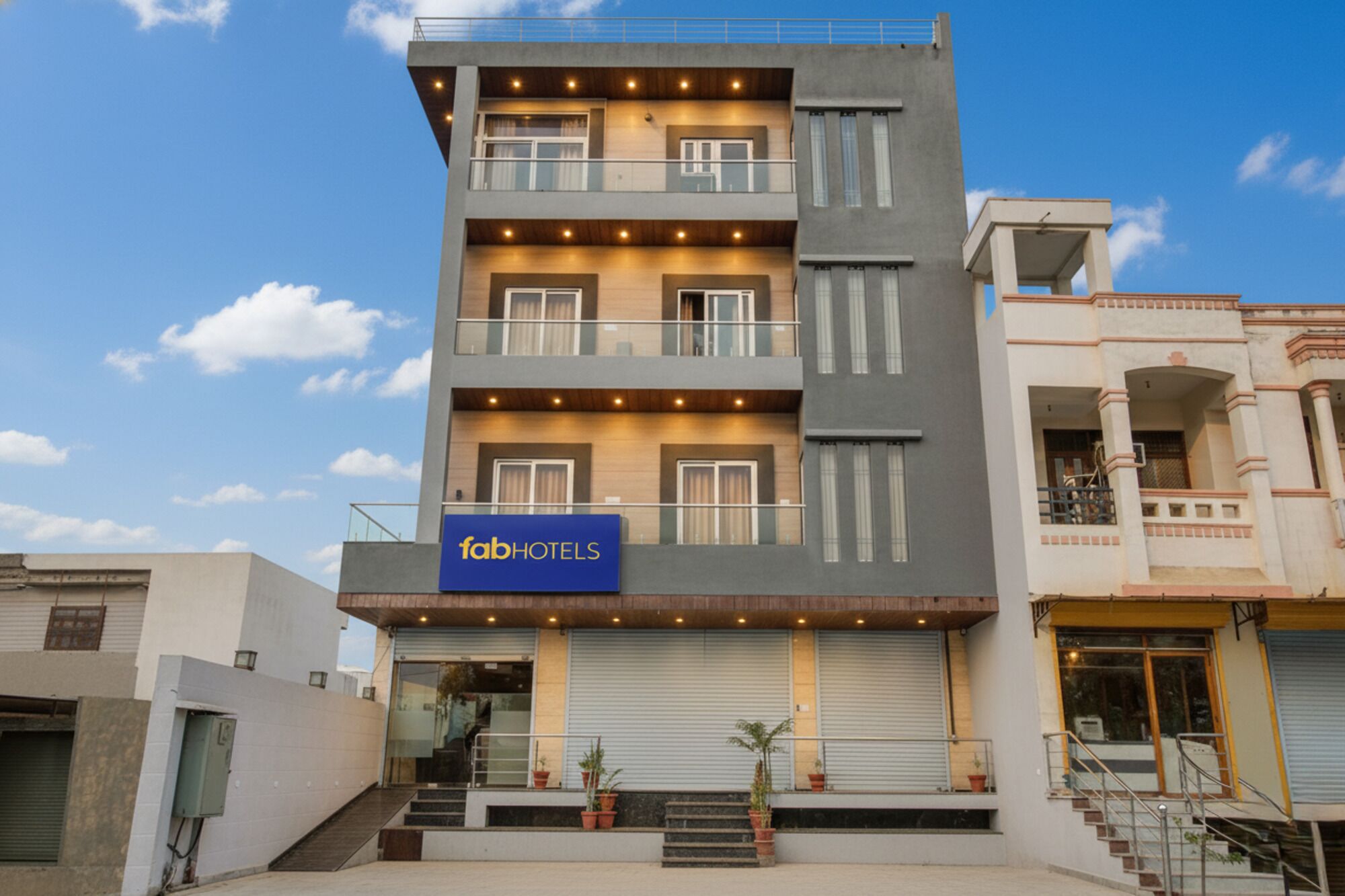 A multi-story building with a sign for 'fabHOTELS'.