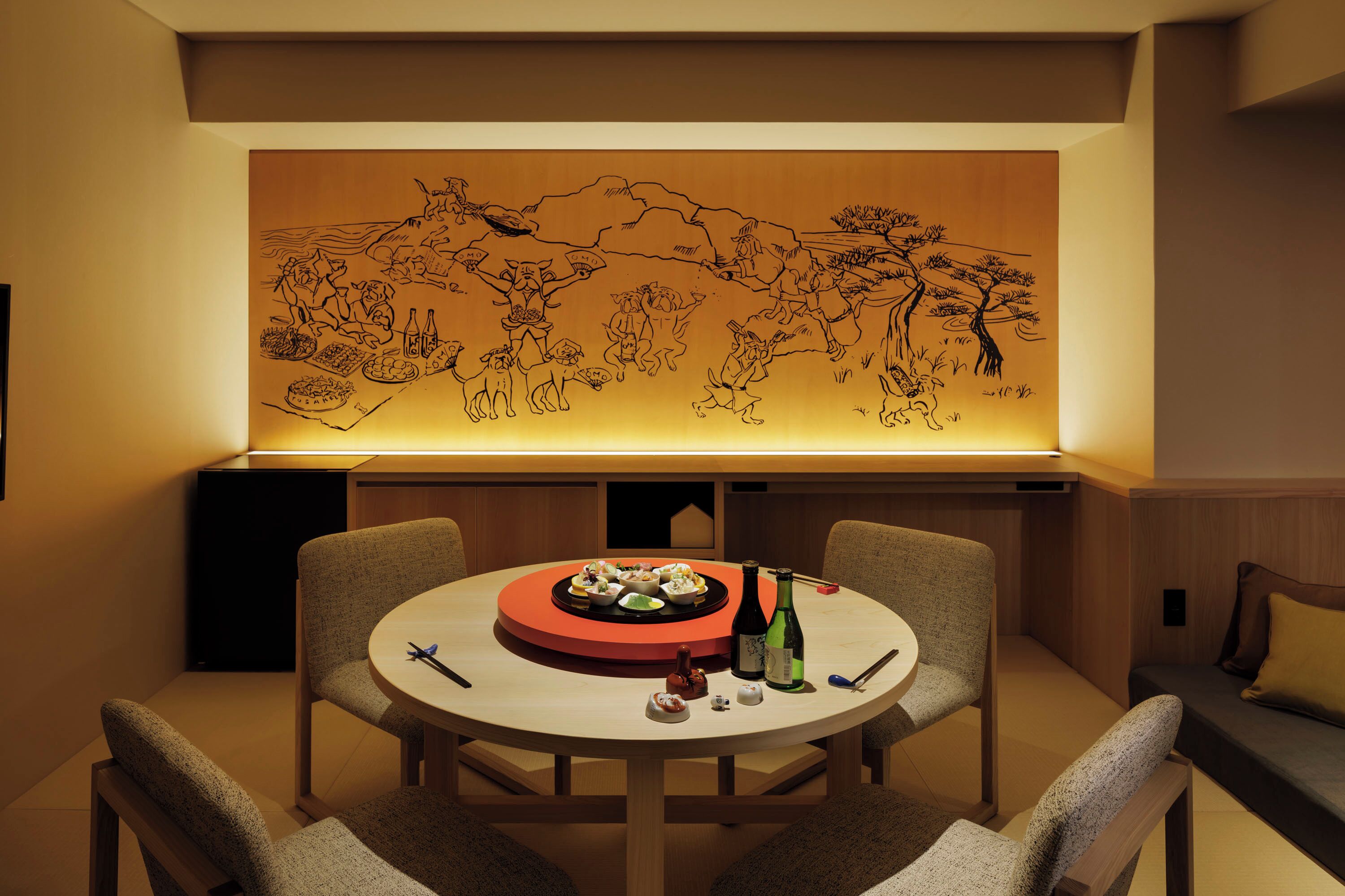 A dining area with a round table, chairs, and a wall-mounted artwork depicting a landscape scene.