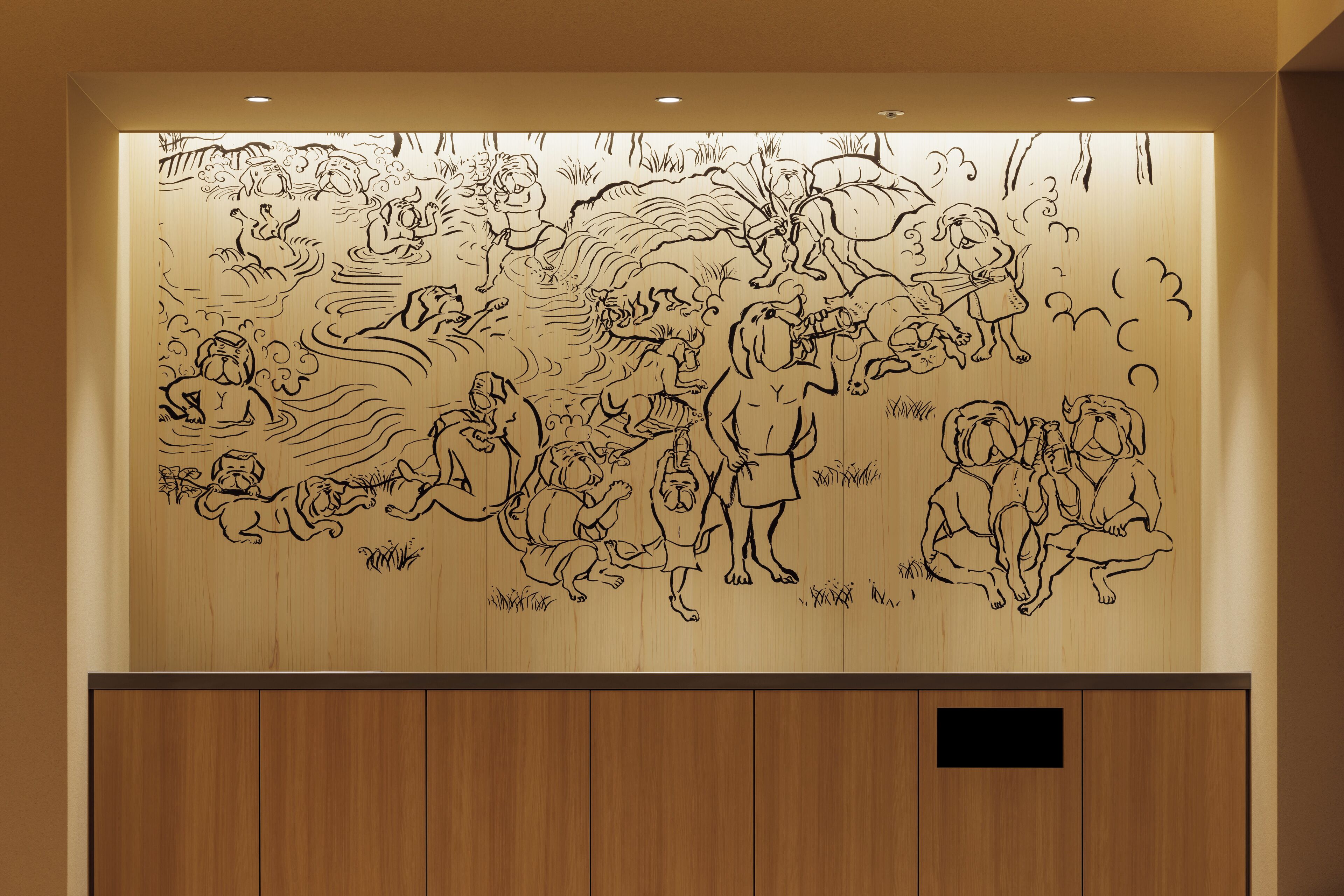 A wall with a large, detailed black and white mural depicting various figures in a dynamic scene.