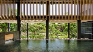 A spa area with a wooden ceiling, stone walls, and a clear pool. - OMO7 Kochi by Hoshino Resorts (Kochi)