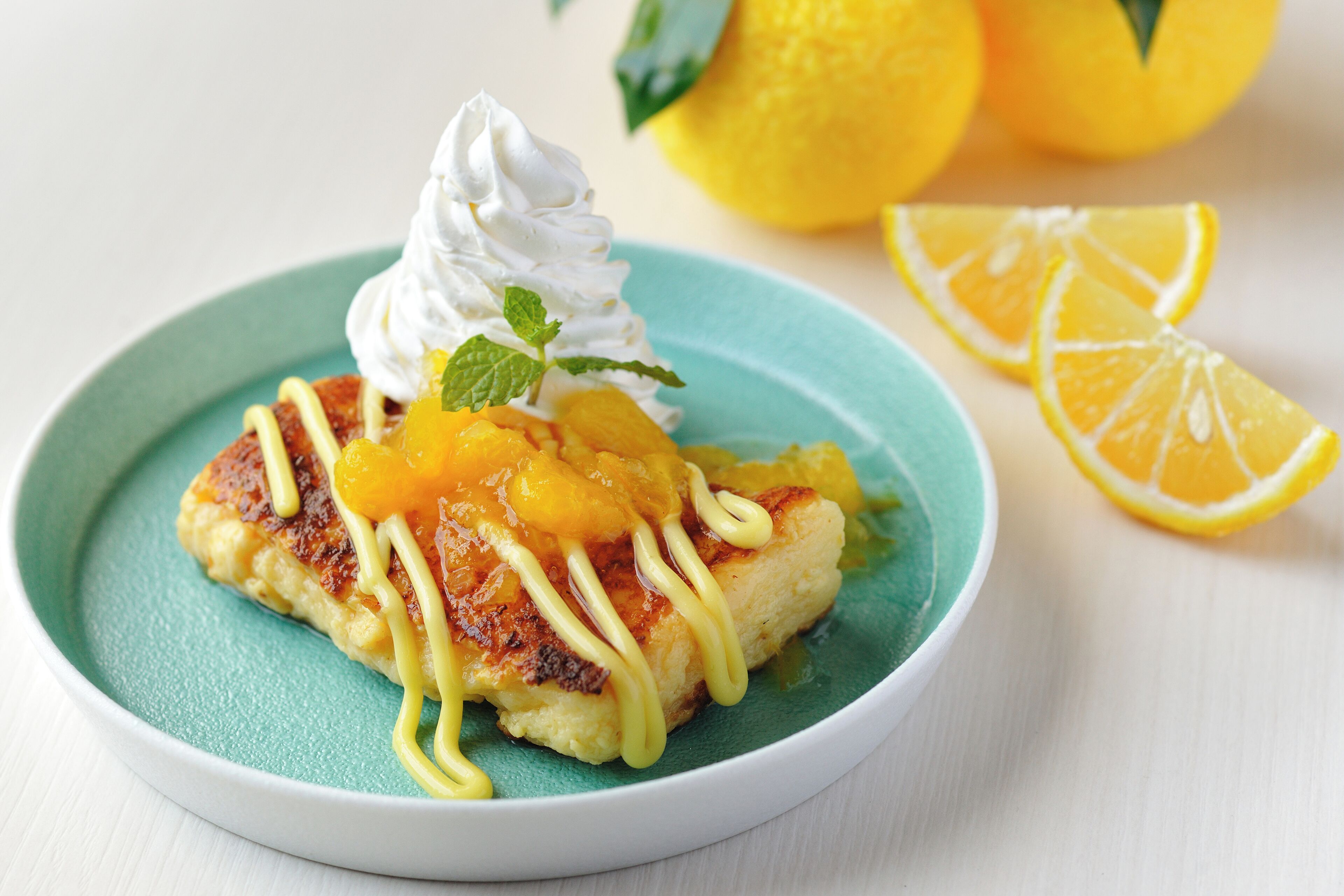 A dessert on a plate with whipped cream and fruit.